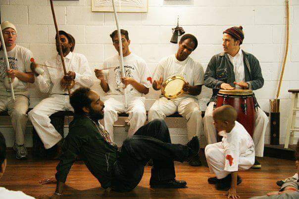 Berimbaus, pandeiro and atabaque played by the bateria on a bench