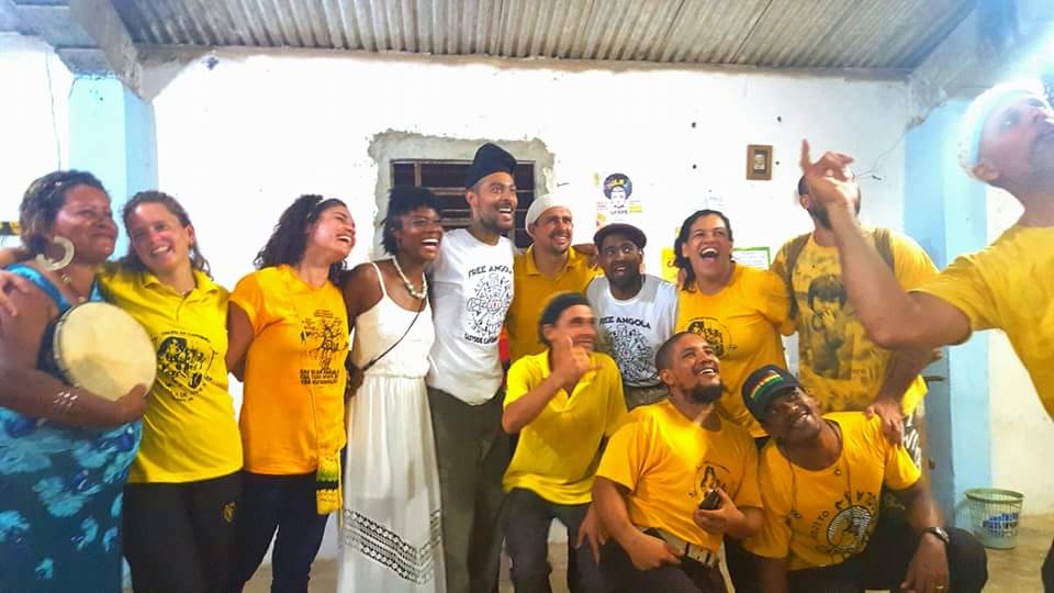 A joyful gathering of capoeira practitioners in Brazil wearing yellow shirts